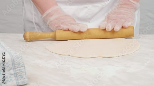 Rolling out tight dough on dumplings requires a lot of effort. Traditional food.