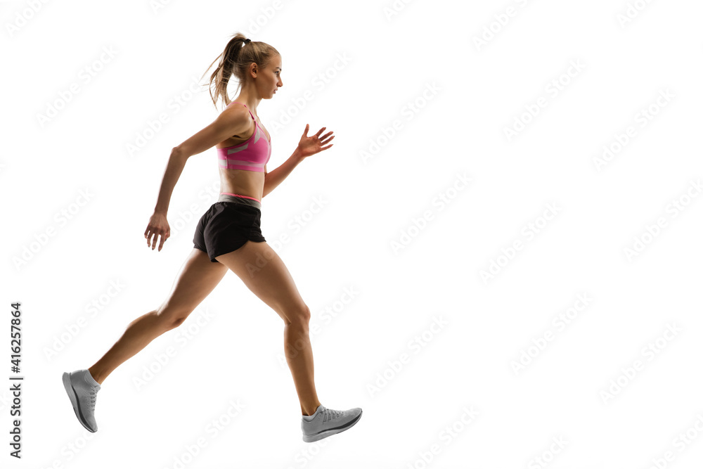 Strong. Caucasian professional female athlete, runner training isolated on white studio background. Muscular, sportive woman. Concept of action, motion, youth, healthy lifestyle. Copyspace for ad. Strong. Caucasian professional female athlete, runner training isolated on white studio background. Muscular, sportive woman. Concept of action, motion, youth, healthy lifestyle. Copyspace for ad.