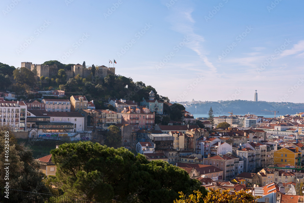 View over the city from the Miradouro da Graça, Lisbon, Portugal, with St George's Castle (Castelo de São Jorge) on the left and the Tagus river in the distance