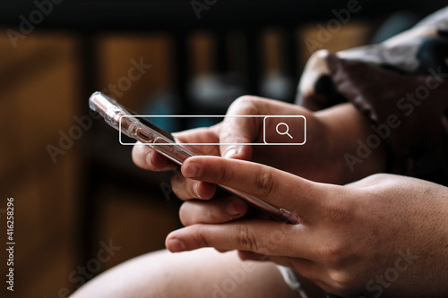 Woman's hands looking at the phone with search bar in the center of the image