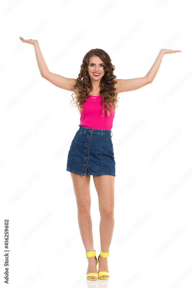 Young Sexy Woman In Mini Skirt And High Heels Is Holding Hands Raised And Presenting Young Sexy Woman In Mini Skirt And High Heels Is Holding Hands Raised And Presenting