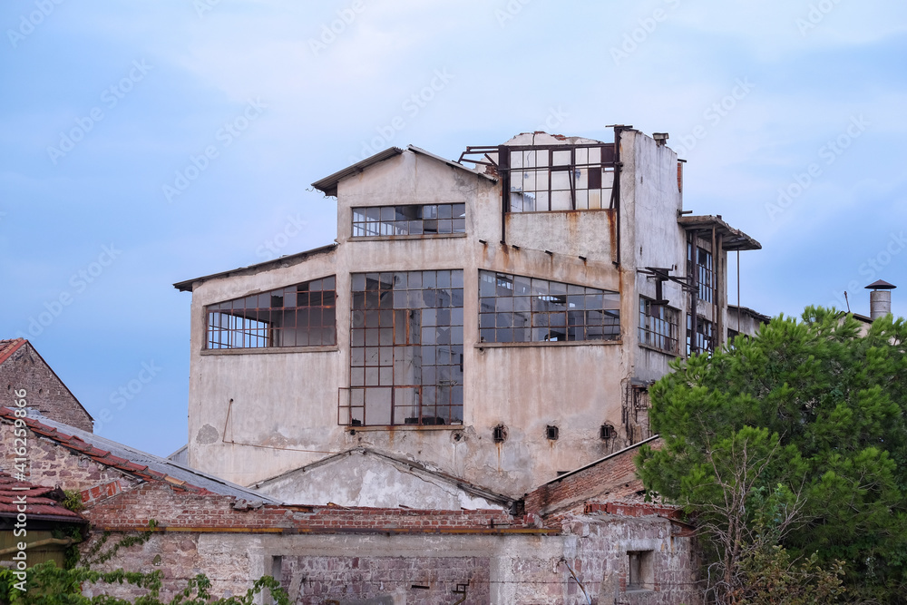 Destroyed abandoned factory, broken glass, destruction, frightening industrial composition