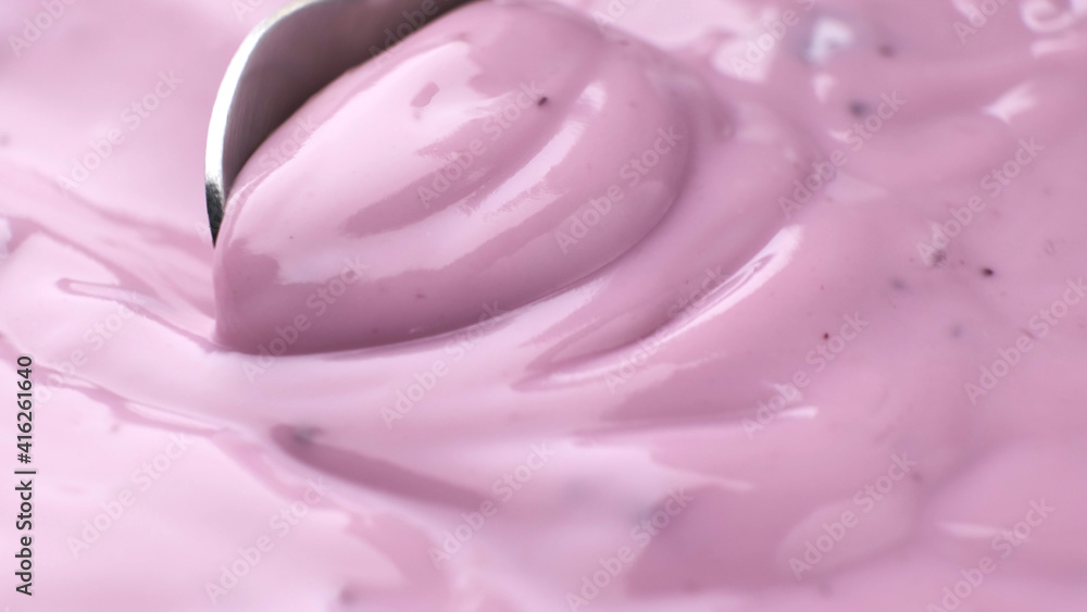 Berry yogurt with spoon, blueberry yogurt close up Berry yogurt with spoon, blueberry yogurt close up