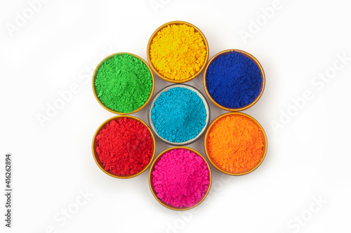 top view of colorful traditional Happy holi powder in bowls isolated on white photo