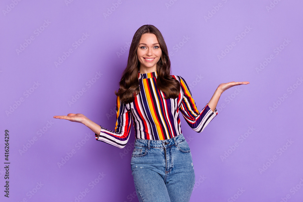 Photo portrait of happy woman keeping blank spaces on hands smiling in casual outfit isolated vibrant purple color background Photo portrait of happy woman keeping blank spaces on hands smiling in casual outfit isolated vibrant purple color background