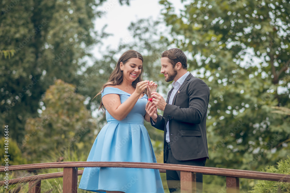 Happy man and woman accepting engagement ring Happy man and woman accepting engagement ring