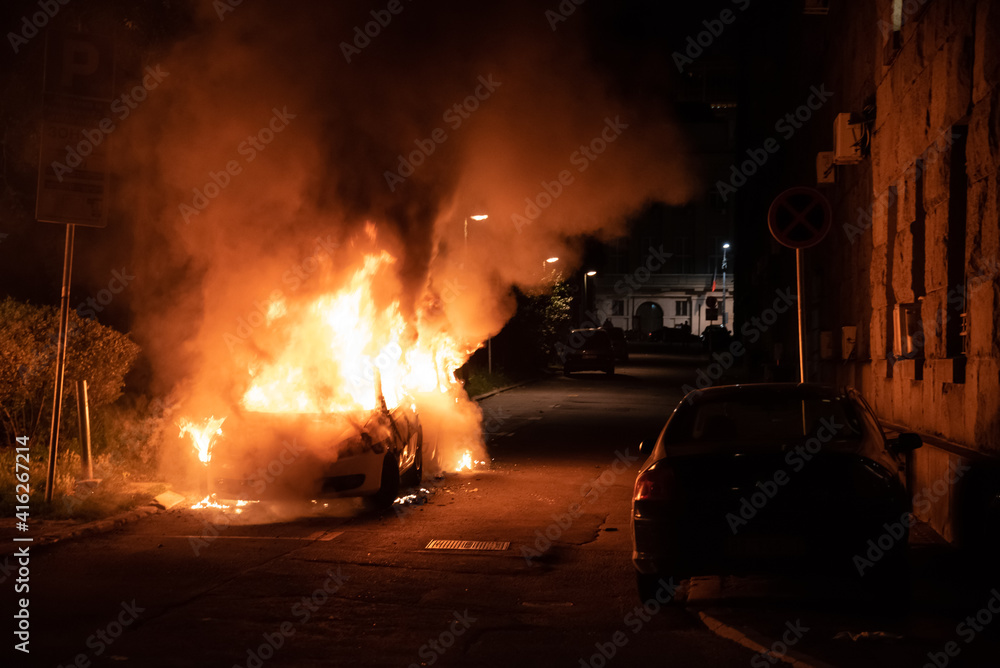 Belgrade, Serbia, 08.07.2020
Burning police car in the center of city near church during riots caused by new measures of coronavirus.