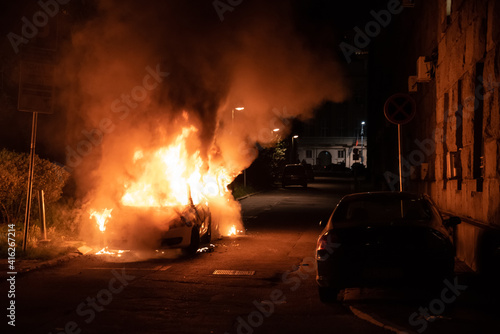 Belgrade, Serbia, 08.07.2020 Burning police car in the center of city near church during riots caused by new measures of coronavirus.