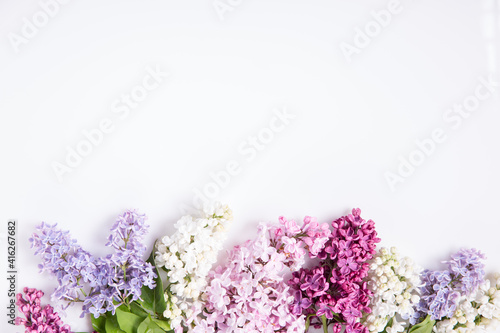 Flowers composition. Frame made of lilac flowers on white background. Flat lay, top view, copy space