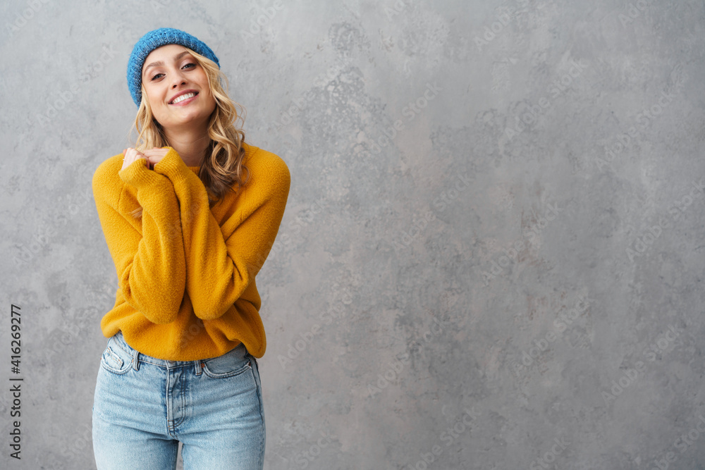 Happy beautiful woman smiling while posing in knit hat Happy beautiful woman smiling while posing in knit hat