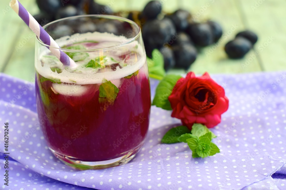 Grape mint soda mocktail with fresh grapes background