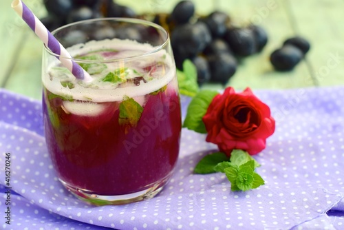 Grape mint soda mocktail with fresh grapes background