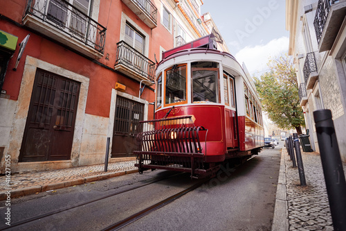 Travel by Portugal. Red old tramway on the street of Lisbon.