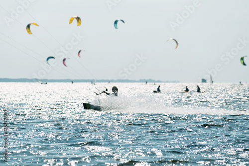 Canvas Print People swim in the sea on a kiteboard or kitesurfing