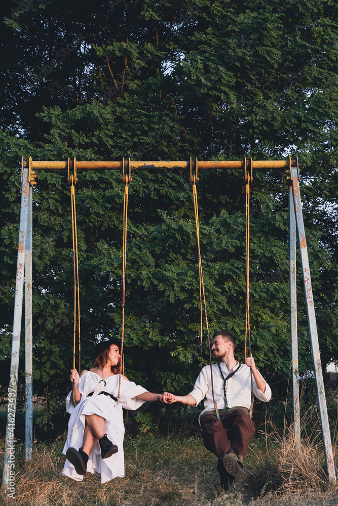 Happy bride and groom on retro swing Happy bride and groom on retro swing
