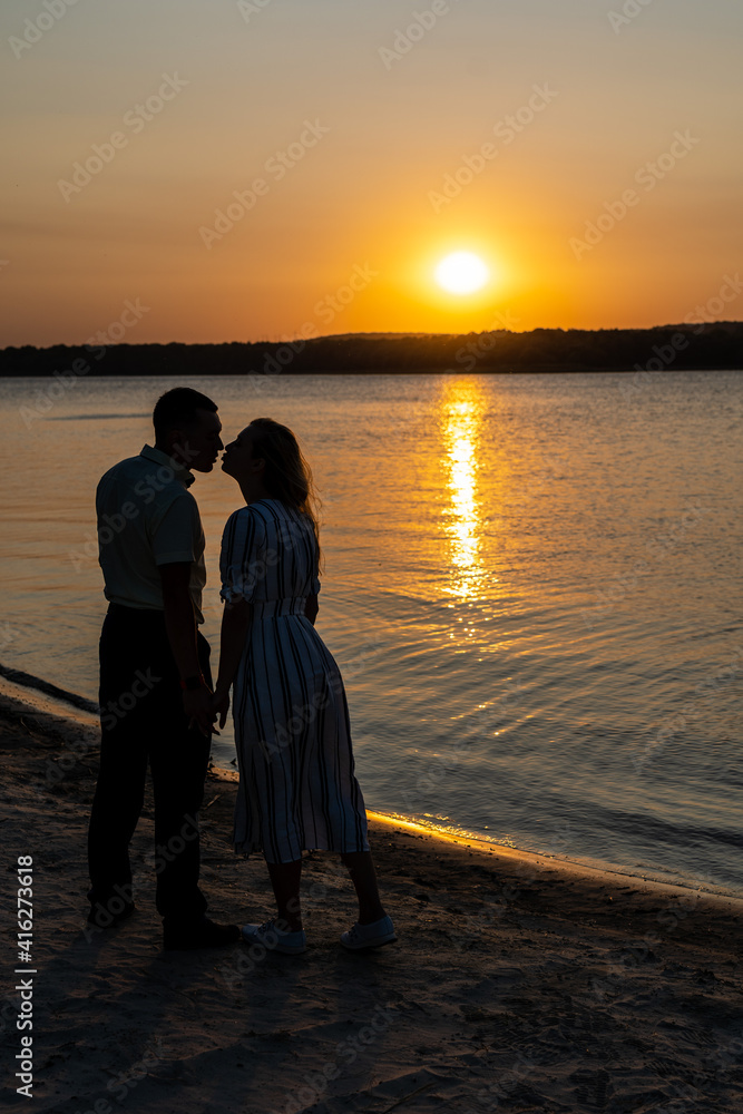 Couple kissing on the sunset on the beach
