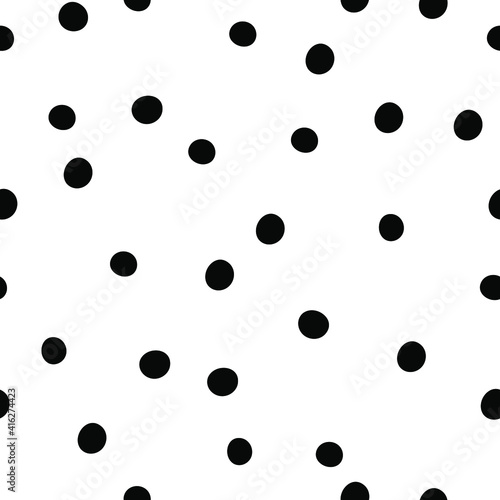 Black polka dots on white background. Seamless doodle pattern with random dots.