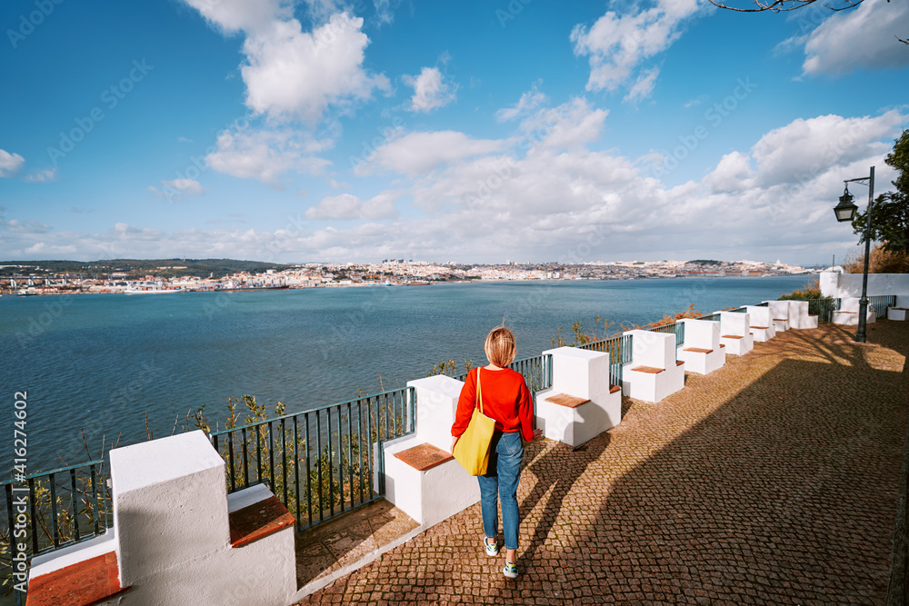 Travel by Portugal. Woman enjoying view of river Tagus.