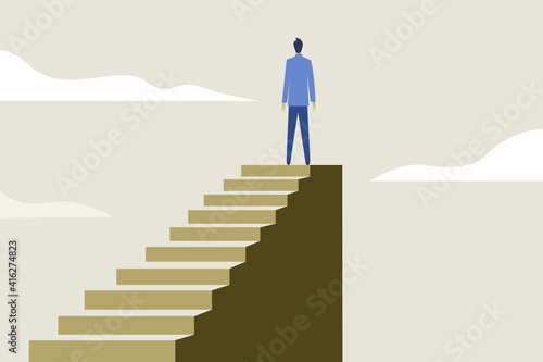 A businessman standing on the top after climbing the steps