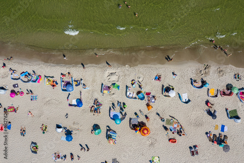 Sunbathing on the beach by the sea. Aerial drone view of Baltic Sea coast in Hel peninsula, Jastarnia. Puck Bay in Poland