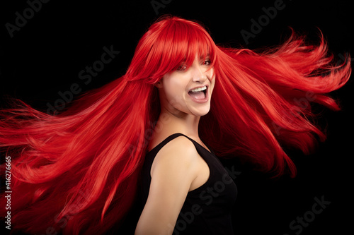 Print op canvas Laughing red-haired girl with fluttering hair