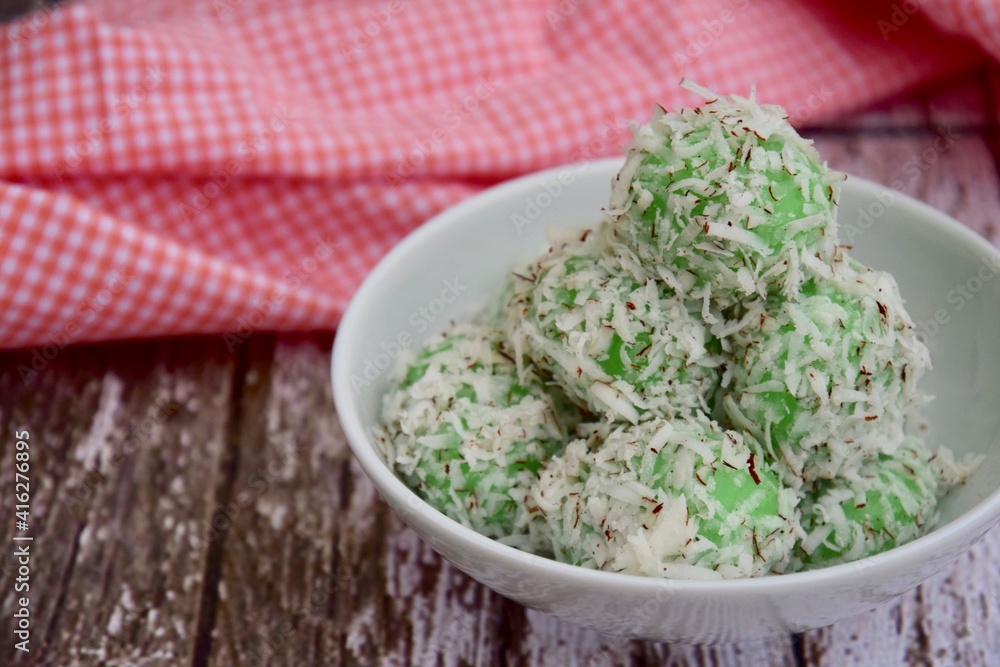 Indonesian Cuisine, Klepon or Traditional Pandanus Rice Balls Made From Glutinous Flour and Grated Coconut with Palm sugar Filling Indonesian Cuisine, Klepon or Traditional Pandanus Rice Balls Made From Glutinous Flour and Grated Coconut with Palm sugar Filling
