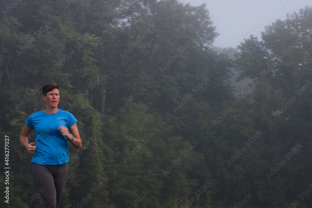 woman running by trees