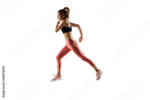 Run. Young caucasian female model in action, motion isolated on white background with copyspace. Concept of sport, movement, energy and dynamic, healthy lifestyle. Training, practicing.