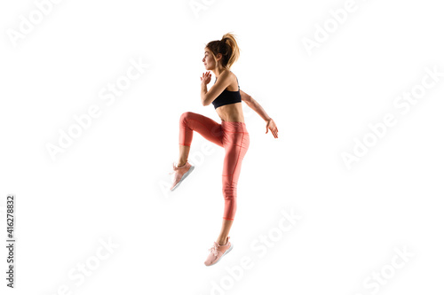 Run. Young caucasian female model in action, motion isolated on white background with copyspace. Concept of sport, movement, energy and dynamic, healthy lifestyle. Training, practicing.