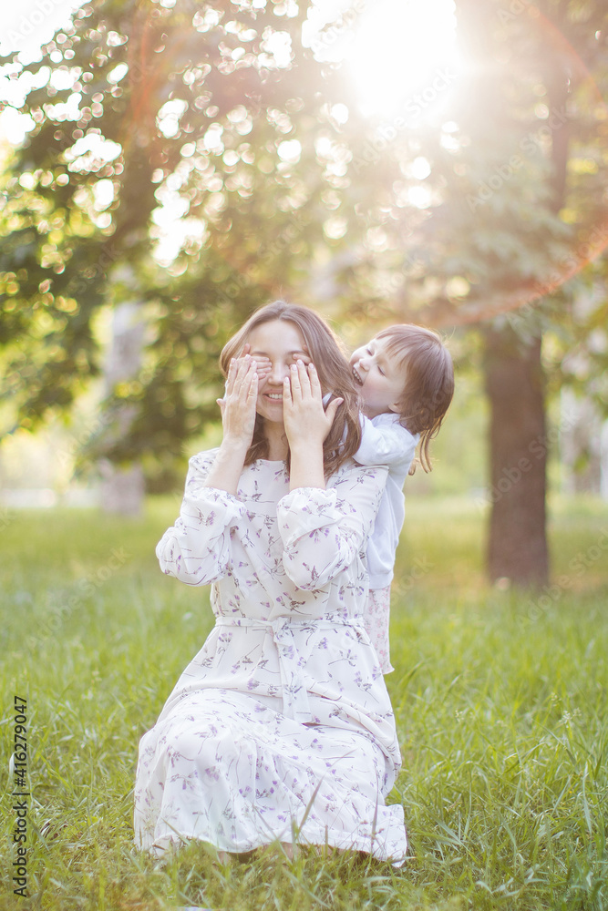 Obraz premium Happy young mother with daughter outdoors.