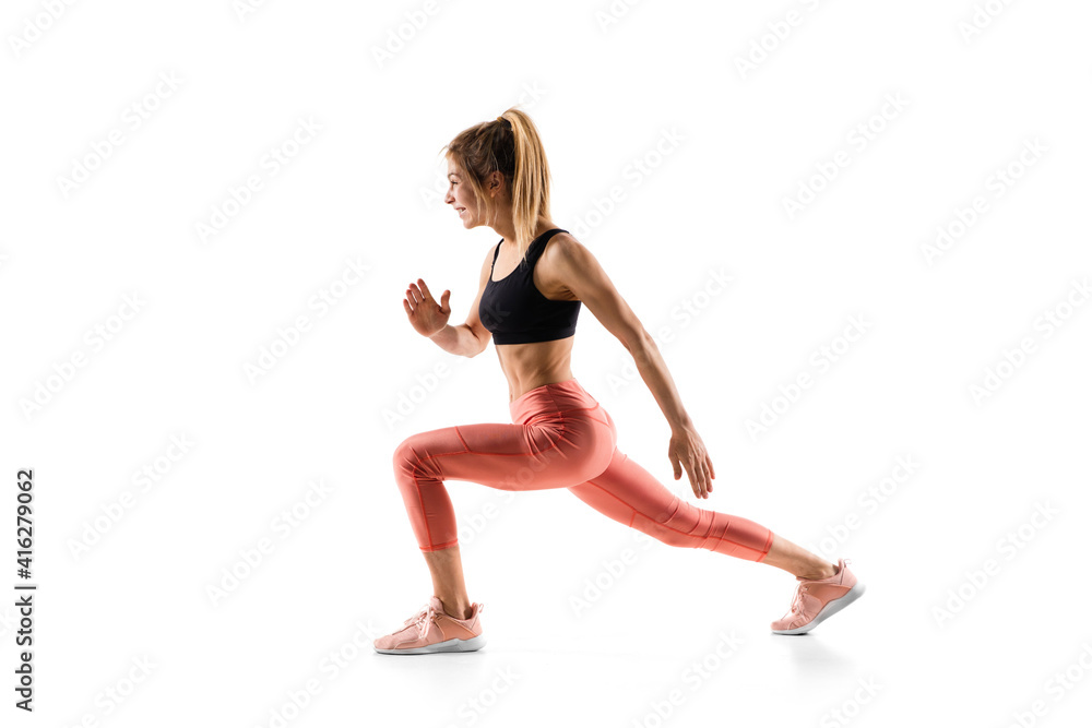 Squats. Young caucasian female model in action, motion isolated on white background with copyspace. Concept of sport, movement, energy and dynamic, healthy lifestyle. Training, practicing. Squats. Young caucasian female model in action, motion isolated on white background with copyspace. Concept of sport, movement, energy and dynamic, healthy lifestyle. Training, practicing.