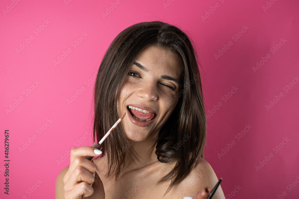 woman applying gloss woman applying gloss