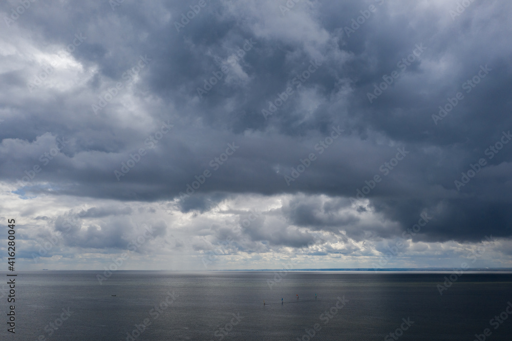 Aerial drone view of  Baltic Sea coast in Hel peninsula, Jastarnia. Drak clouds by the Puck Bay in Poland.