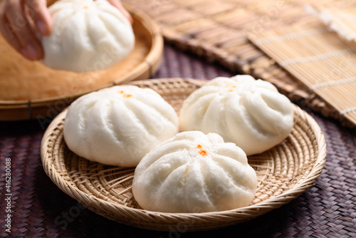 Steamed buns stuffed with minced pork holding by hand, Asian food