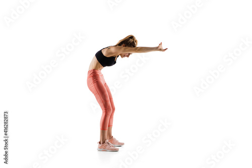 Strong. Young caucasian female model in action, motion isolated on white background with copyspace. Concept of sport, movement, energy and dynamic, healthy lifestyle. Training, practicing.