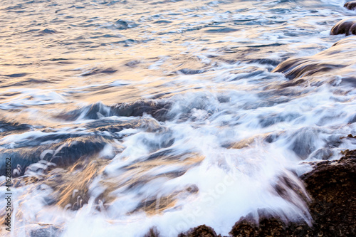 Blurred abstract natural background of sea water with waves and foam. Motion blur. Nature. 