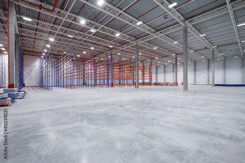 warehouse or hangar. Industrial building interior consist of polished concrete floor and closed door for product display or industry background.