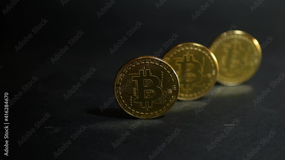Lights falling on bitcoins. Virtual money. Digital currency. Future of business Lights falling on bitcoins. Virtual money. Digital currency. Future of business