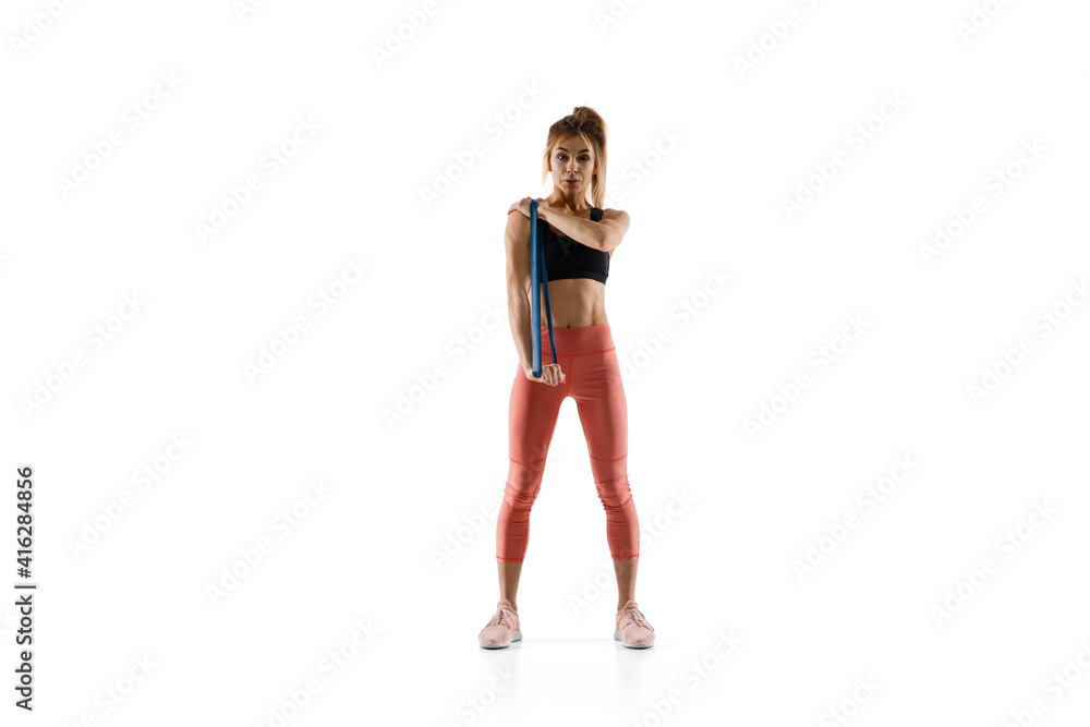 Stretching. Young caucasian female model in action, motion isolated on white background with copyspace. Concept of sport, movement, energy and dynamic, healthy lifestyle. Training, practicing. Stretching. Young caucasian female model in action, motion isolated on white background with copyspace. Concept of sport, movement, energy and dynamic, healthy lifestyle. Training, practicing.