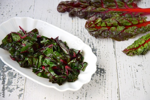 Sautéed chard leaf and fresh leaf on white background
