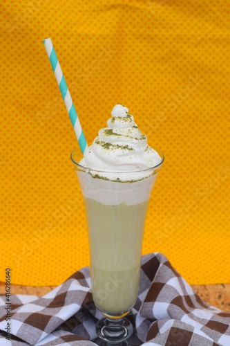 Green tea matcha latte with whipped cream photo