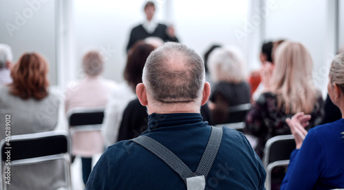 Audience of adult people listen to the speech of the lecturer
