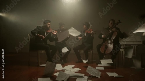 the string quartet plays classical music,notes fall from the air