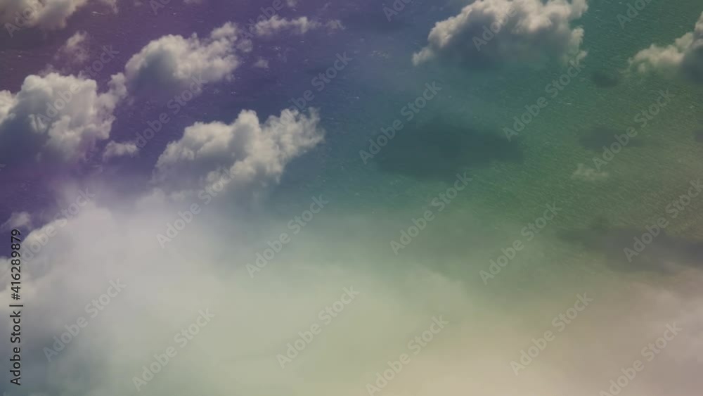 Colorful fantasy water under white clouds view from an airplane above the clouds in the atlantic ocean Colorful fantasy water under white clouds view from an airplane above the clouds in the atlantic ocean