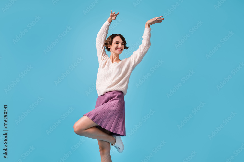 Photo of young cheerful girl happy positive smile excited crazy have fun look empty space isolated over blue color background Photo of young cheerful girl happy positive smile excited crazy have fun look empty space isolated over blue color background