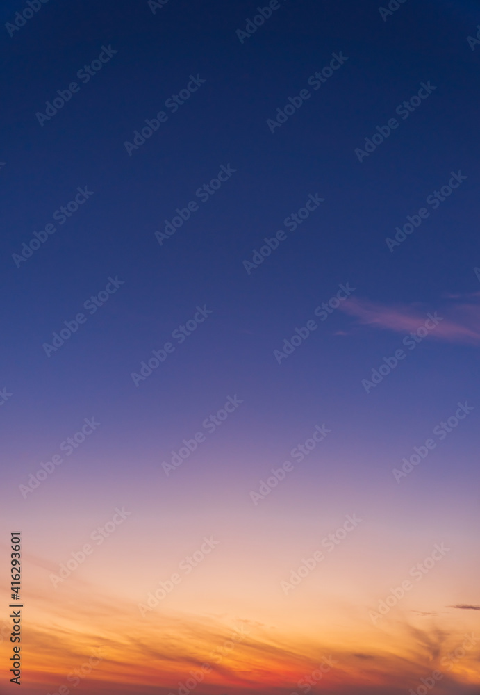 Dusk sky vertical with colorful sunlight and dark blue sky in the evening on twilight background 