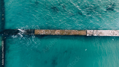 Aerial View of Old pier and turquoise sea in winter time. Black sea, Odessa, Ukraine © Bohdan Melnyk