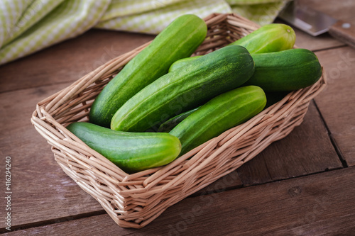 Fresh cucumber in wicker basket