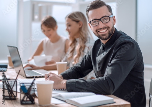 smiling businessman in the workplace in the office