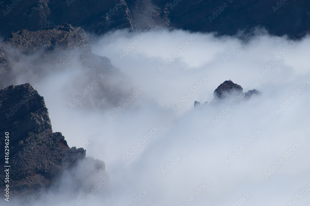 Fototapeta premium Cliffs of a volcanic crater and sea of clouds.